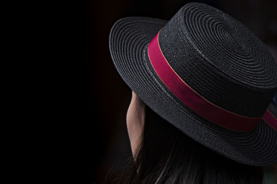 Close-up of hat against black background