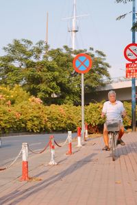 Man riding bicycle on road