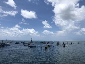 Boats moored in sea against sky