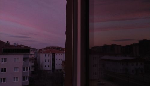 Buildings against sky at sunset