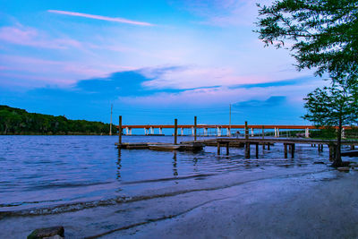 Pier on lake against sky