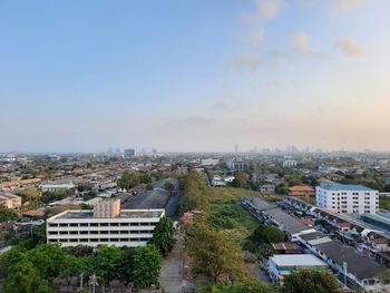 High angle view of buildings and trees against sky