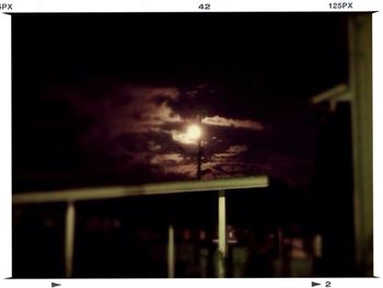 Low angle view of silhouette moon against sky at night