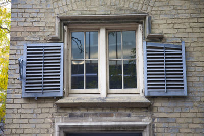 Low angle view of window on old building