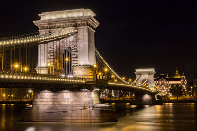 Low angle view of suspension bridge at night