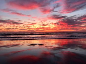 Scenic view of sea against romantic sky at sunset