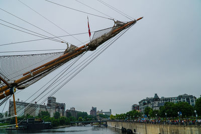 Cranes in city against sky