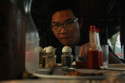Portrait of teenage boy sitting at restaurant table