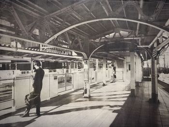 Low angle view of woman standing on railing