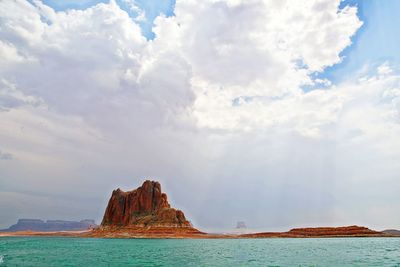 Rock formations in sea against sky