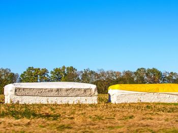 Scenic view of field against clear blue sky