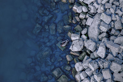 Directly above shot of stones by lake