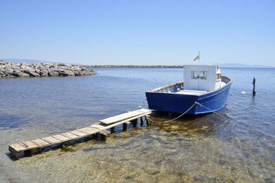 Nautical vessel on sea against clear blue sky