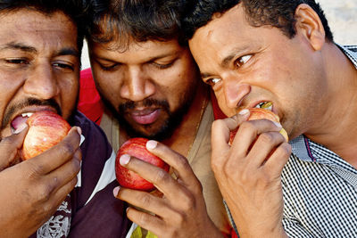 Portrait of men eating food