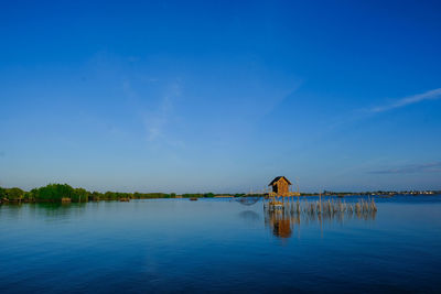 Scenic view of lake against blue sky