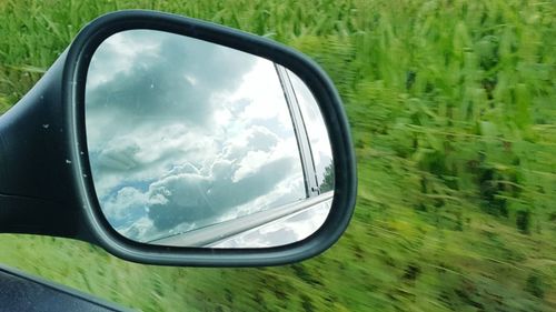 Reflection of sky on side-view mirror