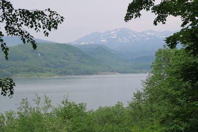 Scenic view of lake and mountains against sky