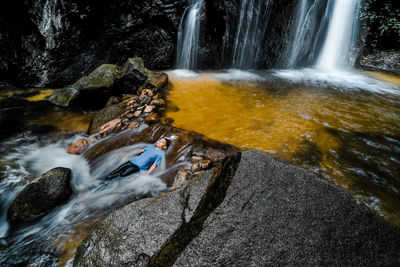 Boy enjoying waterfall