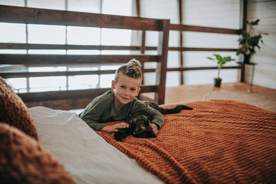 Portrait of boy relaxing on bed at home