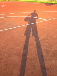 Shadow of man standing on soccer field
