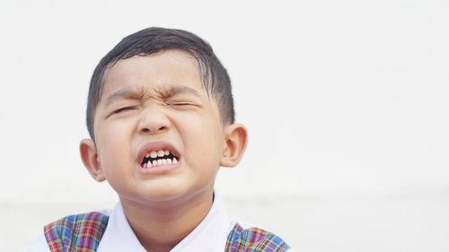 Portrait of boy against white background