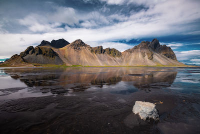 Scenic view of lake and mountains against sky