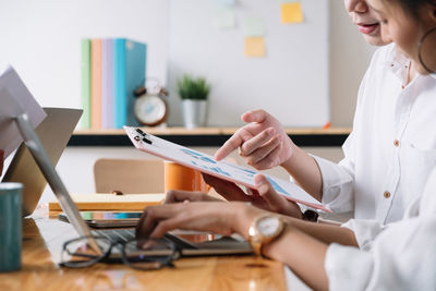 Women reviewing graph in office