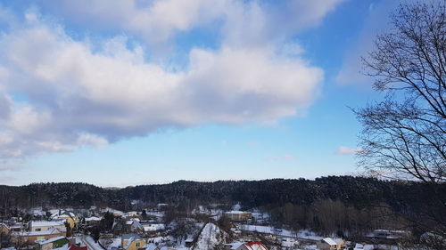 Panoramic view of houses against sky during winter