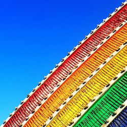 Low angle view of buildings against clear blue sky