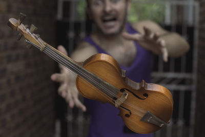 Man reaching for his levitating violin. 