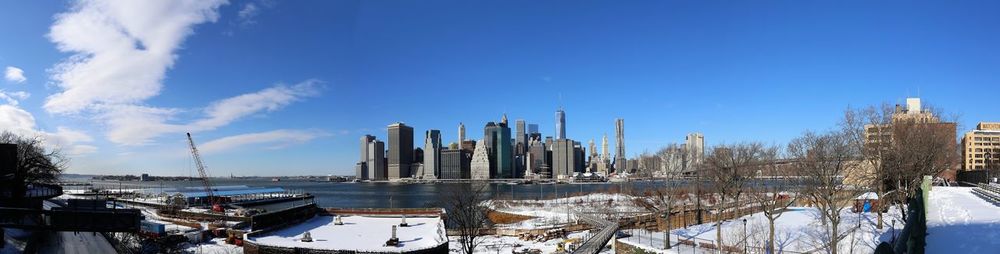 Panoramic view of buildings against sky during winter