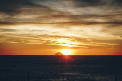 Scenic view of sea against orange sky