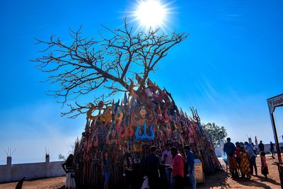 Group of people against blue sky