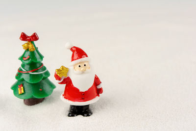 Stuffed toy on snow against white background