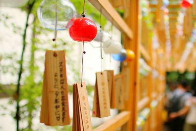 Close-up of lantern hanging on wood