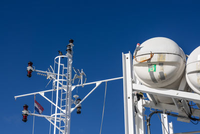 Low angle view of lighthouse against clear blue sky