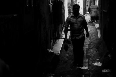 Rear view of man walking in corridor