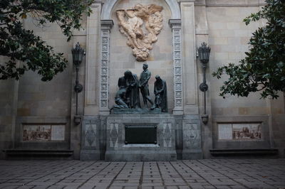 Statue against historic building