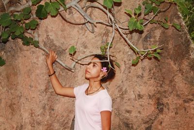 Full length of woman standing by plants