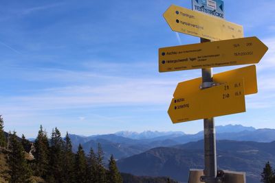 Information sign on landscape against sky