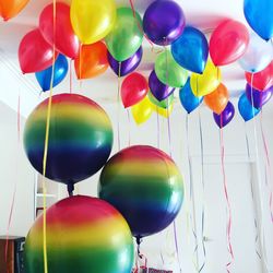 Low angle view of multi colored balloons