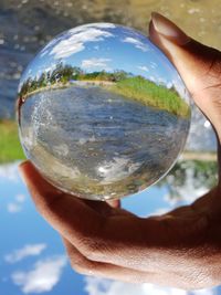 Close-up of person hand holding glass of crystal ball