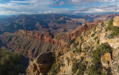 Scenic view of rocky mountains against cloudy sky