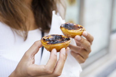 Woman holding pastel de nata