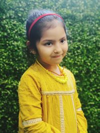 Portrait of cute girl standing outdoors
