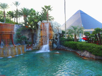 View of fountain in front of waterfall