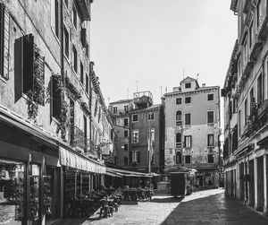 Street amidst buildings against clear sky