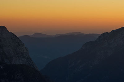 Scenic view of silhouette mountains against sky during sunset