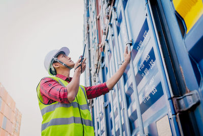 Low angle view of person standing against the wall