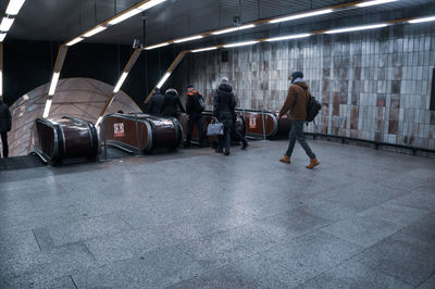 Rear view of people walking in city